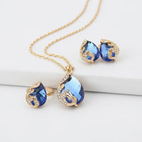 Set di collana e orecchini in oro con cristallo blu