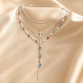 Parure di collana e orecchini in oro bianco con pietre multicolori