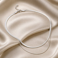 Collana a strati con serpenti in oro bianco
